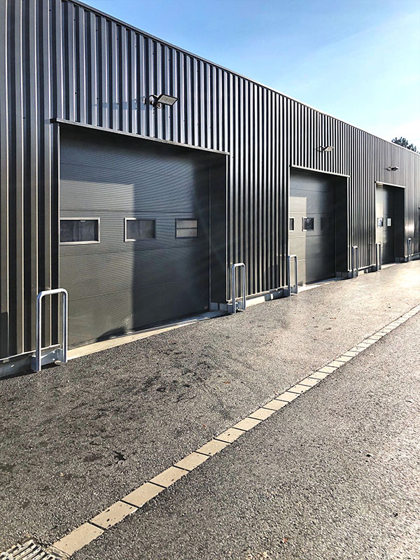 sectional doors with collision protection guard
